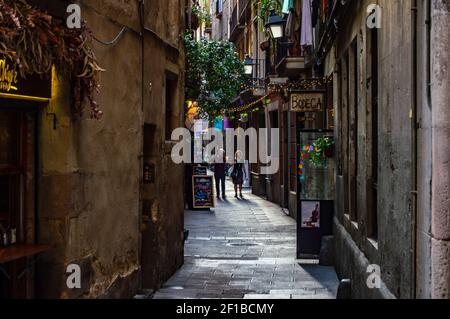 Barcelona, Spain - July 25, 2019: Lively street with lights, cafes and shops in the Roman quarter of the city of Barcelona, Spain Stock Photo