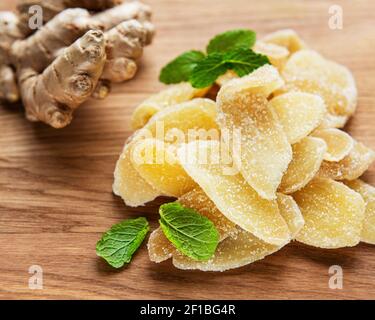 Sweet and spicy candied ginger on a old  wooden table Stock Photo