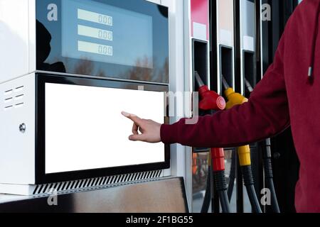Self-service filling station. A man using a touchscreen  Stock Photo