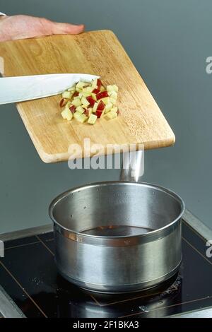 The cook sips the ingredients in a pan for cooking mulled wine full of culinary recipes Stock Photo