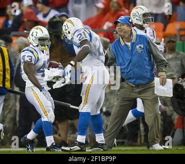 San Diego Chargers' LaDainian Tomlinson (21) is tackled by Tennessee  Titans' Stephen Tulloch, center, and Keith Bulluck, right, on a two-yard  run during the second quarter of their AFC wild-card game Sunday