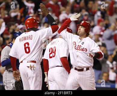 Philadelphia Phillies Ryan Howard congratulates teammate Chase Utley after  he hit a solo home run in the 6th inning off of Tampa Bay Rays Matt Garza  in game three of World Series