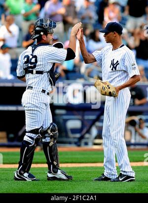 New York Yankees Derek Jeter hugs Sergio Mitre after hitting