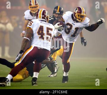 Washington Redskins Rock Cartwright (31) is tackled by New York Giants  Gerris Wilkinson (59) during their game played at FedEx Field in Landover,  Maryland, Sunday, November 30, 2008. (Photo by Harry E.