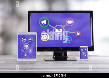 Online communication concept shown on different information technology devices Stock Photo