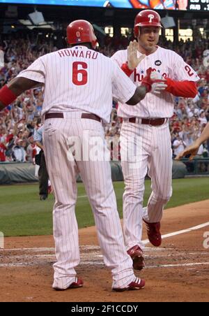 Philadelphia Phillies Ryan Howard congratulates teammate Chase Utley after  he hit a solo home run in the 6th inning off of Tampa Bay Rays Matt Garza  in game three of World Series