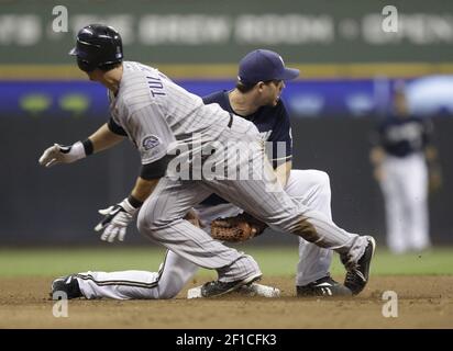 Milwaukee Brewers' J.J. Hardy (L) is safe at third base as San Diego Padres  tries to throw out Ryan Braun at second base during the fifth inning at  Miller Park on September