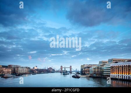 The River Thames and Tower Bridge with London Bridge Hospital (right foreground) & Canary Wharf (distance), seen from London Bridge, London, UK Stock Photo