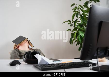 Bored woman sleeping at workplace. Remote work at home Stock Photo