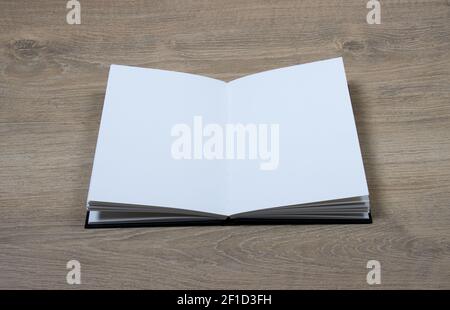 open sketchbook with blank pages on wood background Stock Photo