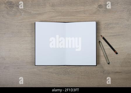 open sketchbook with blank pages on wood background Stock Photo