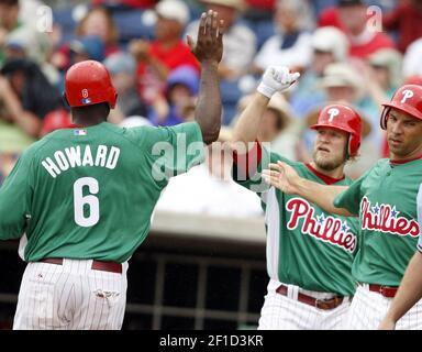 Philadelphia Phillies' Jayson Werth, second from left, Matt Stairs, second  from right, and Ryan Howard, right, sit in the dugout during a rain delay  during the sixth inning of the second game