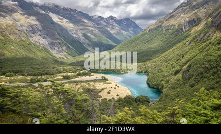 Pristine alpine lake hidden in the mountain valley, shot at Blue Lake, Nelson Lakes National Park, New Zealand Stock Photo