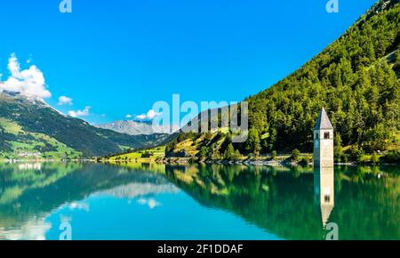 Submerged Bell Tower of Curon on Lake Reschen in South Tyrol, Italy Stock Photo
