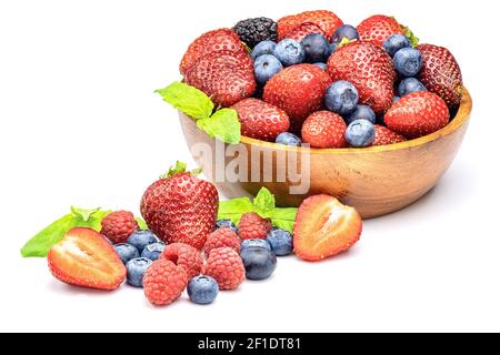 Mixed sweet fresh berries on white background. Ripe strawberry, raspberry, blueberry and mint leaves. Stock Photo
