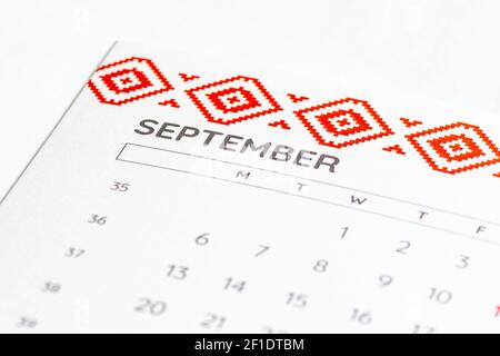 Syringe, glass vial or phial and calendar with month of September on a