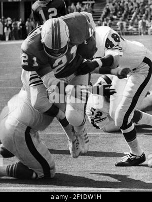 Miami Dolphin back Jim Kiick (21) seems totally unaware that he is about to  be trounced by New York Jets John Elliott (80) during action in their AFL  game Sunday afternoon Dec.