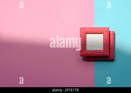 Design concept - top view of two red photo frames isolated on blue and pink background for mockup. Copy space. Stock Photo