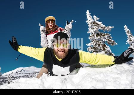 Couple snowboarders or skiers are having fun at ski resort. Sheregesh, Siberia, Russia Stock Photo