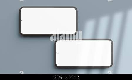 Two horizontal mobile phones mockup isolated on a blue background in flat lay and 3D rendering. Realistic template of cellphone frame and blank displa Stock Photo
