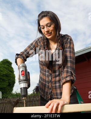 Craftsperson Woman Uses Power Screwdriver Drilling Holes Wood Stock Photo