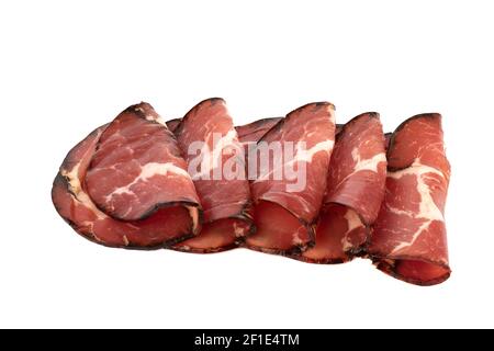 Folded in half dry-cured smoked pieces of pork neck isolated on white background. Close up. Copy space. Stock Photo