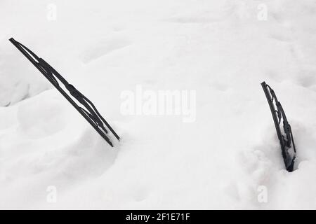 Car windshield wipers covered by snow. Winter time. Blocked vehicle Stock Photo