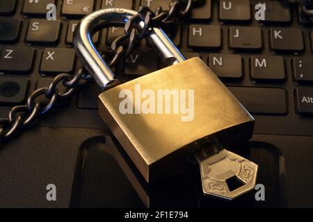Detail of a metallic security padlock above a computer keyboard, Stock Photo