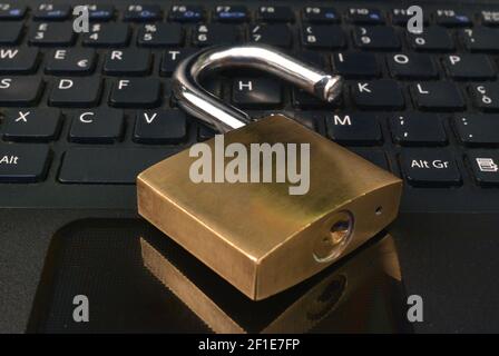 Detail of a metallic security padlock above a computer keyboard, Stock Photo