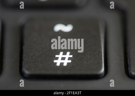 The hash and tilde key on a laptop keyboard Stock Photo - Alamy