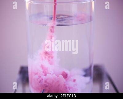 Closeup of a pink liquid in water in a science lap Stock Photo