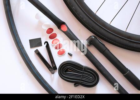 Bicycle tube repairing tools on white background. Concept of essential tools for cycling Stock Photo