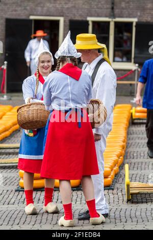 Cheese vendors in traditional costume at Alkmaar Cheese Market, Netherlands Stock Photo