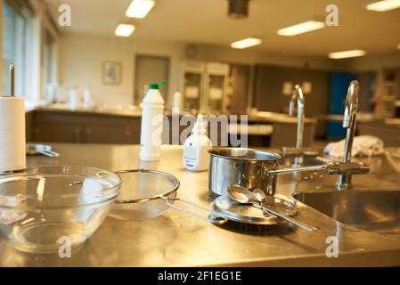 Closeup of a cooking class in school with used kitchen utensils Stock Photo