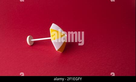colorful beach umbrella on red background Stock Photo