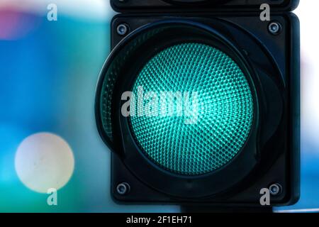 closeup of traffic semaphore with green light on defocused city street background with copy space Stock Photo