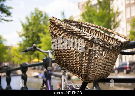 Bicycle with wicker basket on the street Stock Photo