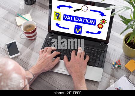 Validation concept shown on a laptop used by a man Stock Photo