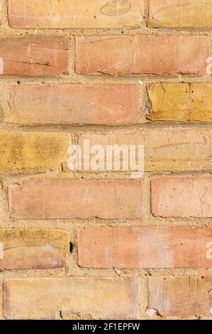 Wall with brickwork under the old destroyed brick of light beige. White mortar, texture, close-up. Stock Photo