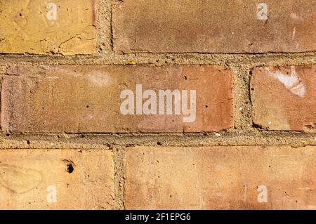 Wall with brickwork under the old destroyed brick of light beige. White mortar, texture, close-up. Stock Photo