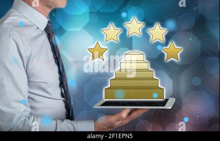 Quality concept above a tablet held by a man Stock Photo