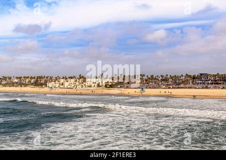 Famous Huntington Beach shoreline during a bright, sunny day shows the water movement and popular shoreline. Stock Photo