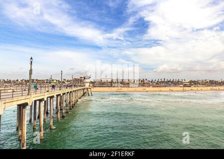 The iconic Huntington Beach pier hosts millions of tourists annually.  The views are simply beautiful, especially during vibrant sunny days. Stock Photo