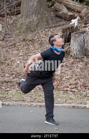 A n athletic nimble young Chinese American man plays Jianzi in a park in Queens, New York City. Stock Photo