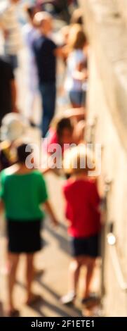 Blurry photo of kids climbing wall at playground at Seine river embankment park in Paris (France) while parents watching and guarding. Paris is wonder Stock Photo