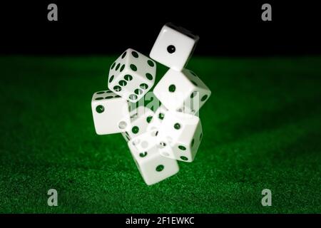 Dices being trown on a green flet with motion blur Stock Photo