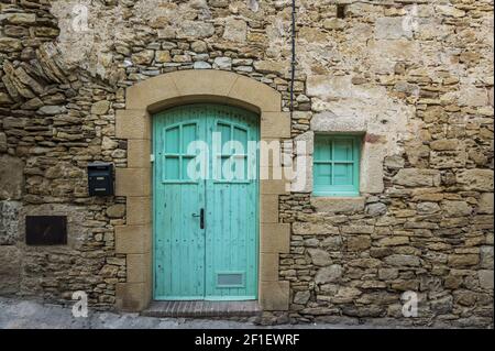 Blue door in an old building made of stone Stock Photo