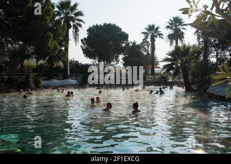 Unidentified tourists bath in the Antique pool or Cleopatra's Bath in Pamukkale, Turkey Stock Photo