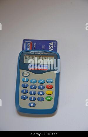 A Nationwide Building Society bank card reader for secure internet banking with a Visa debit card inserted Stock Photo