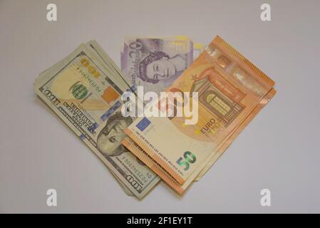 A selection of UK pound sterling, Euro and US dolar banknotes on a white background Stock Photo